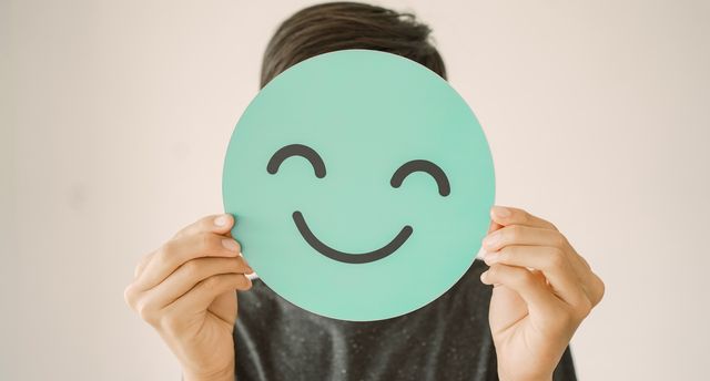 Happy,Mixed,Asian,Teen,Boy,Holding,Smile,Emoji,Face,,Positive